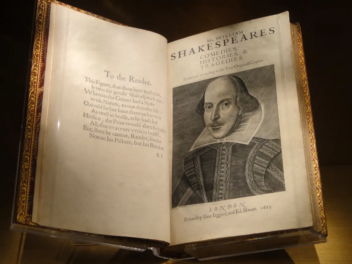 A copy of Shakespeare's First Folio (1623) open at the Folger Shakespeare Library, Washington DC, showing the Droeshout portrait and Ben Jonson's 'To the Reader' poem